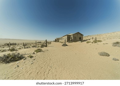 An artistic image of Kolmanskop's former bowling alley, the skeletal structure filled with sand, showcasing the power of nature reclaiming man-made spaces.