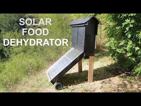 A meticulously constructed DIY Solar Food Dehydrator made from repurposed corrugated metal, reclaimed barn wood, and glass panels.