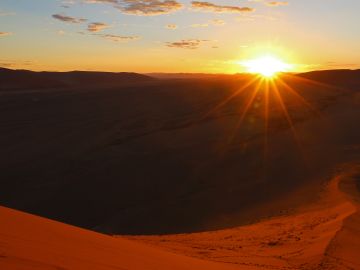 Namibian landscape featuring vast desert plains and a clear blue sky, showcasing the transition from civilization to the desolate landscape