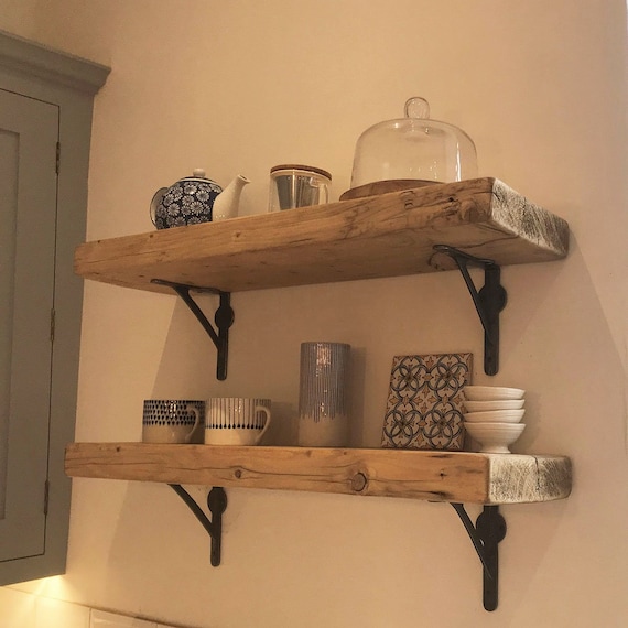 Overhead, instructional photographs showing step three in creating the hanging herb drying rack. The image is well-lit (using diffused natural light from a north-facing window), and clearly shows the materials and process, focusing on the textures of the reclaimed wood, the details of the copper wire, and the use of the drill and pliers. Maintain a clean, uncluttered background. Quality should be 4k, high resolution, professional photography, shot with a Nikon D850 and a macro lens.