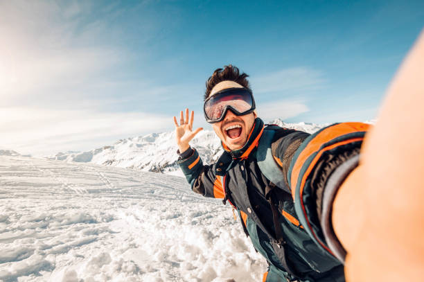 A snow skydiver in mid-air, with snow-covered mountains below, showcasing the thrill of snow skydiving.