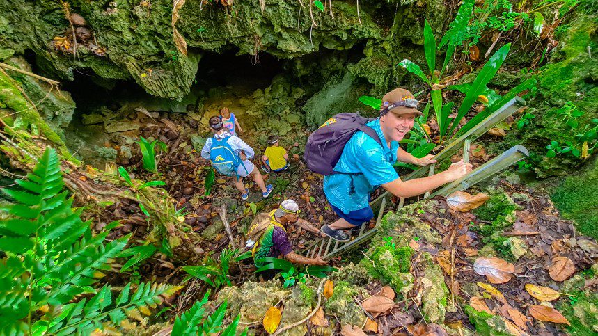 Guide showing tourists native birds at Atiu Bird Sanctuary