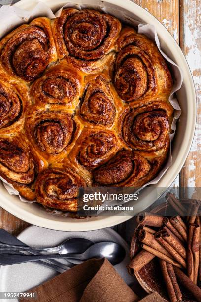Image of a sliced zucchini bread with cinnamon streusel on a plate, next to a cup of coffee in a rustic setting.