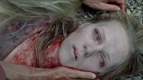 Saga Anderson investigating a crime scene in a dark forest