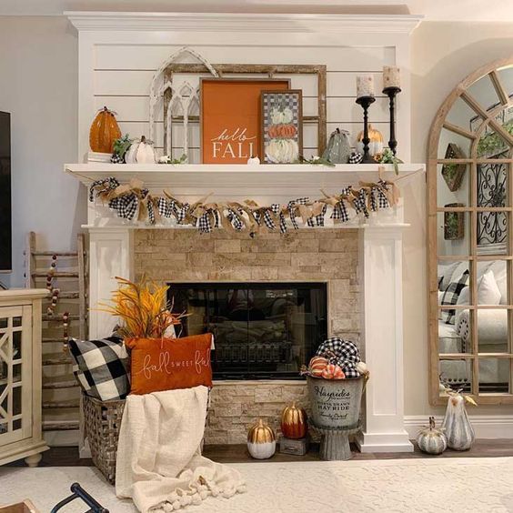 An arrangement of pumpkins, gourds, and other autumn foliage is displayed on a weathered wooden table, exemplifying the natural farmhouse aesthetic.