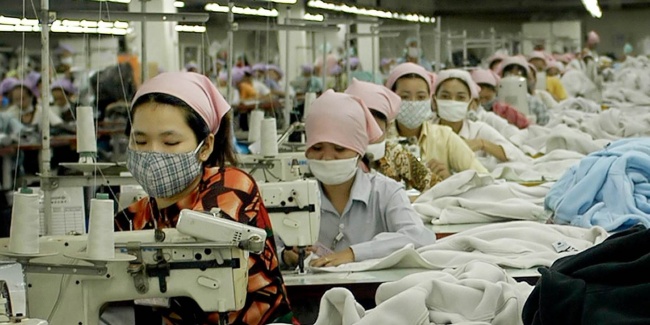 A behind-the-scenes look inside an ethical factory, filmed with a handheld camera to emphasize fair labor practices and safe working conditions.