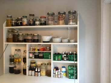 Assortment of preserved food displayed in a pantry, including various jars and cans.