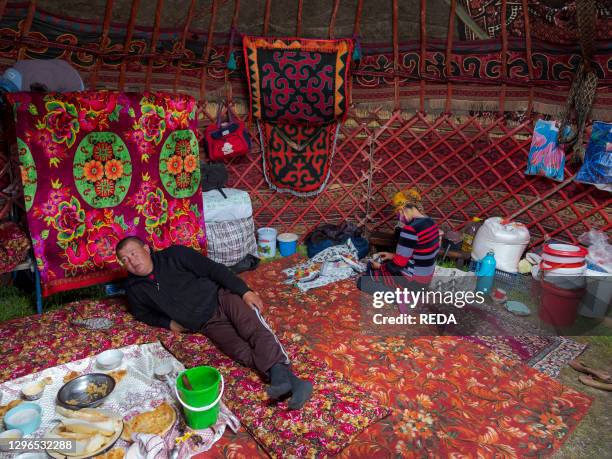 A panoramic shot of the Zorkul lake reflecting the towering Pamir peaks, taken at dawn with a long exposure to capture the smooth surface of the water and the sharp details of the surrounding mountains.
