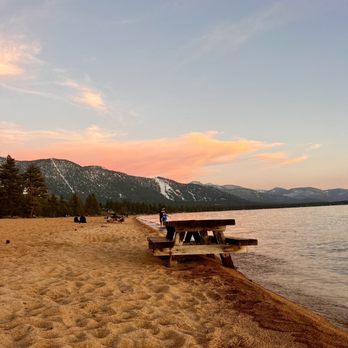 Emily and Ben setting up their tent at campsite #23, with a view of the surrounding trees