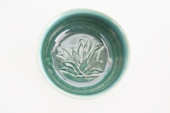 A mezcal tasting flight, featuring different varieties of mezcal in small copitas, highlighting the amber hues of the liquid and the elegant presentation.