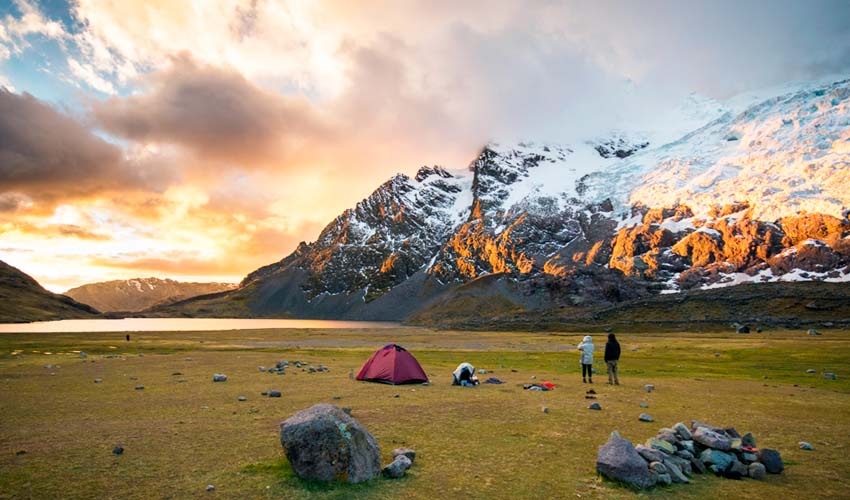 Machu Picchu shrouded in mist at dawn. The historical significance and the surrounding mountainous landscape are palpable. This image captures the magic of the Inca Trail.