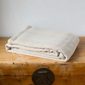A natural stone soap dish is displayed in a cozy, naturally lit bathroom, adding a touch of earthy elegance to the winter solstice theme.