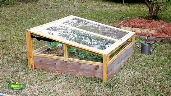 A cold frame built directly on top of a raised garden bed, showcasing easy access.