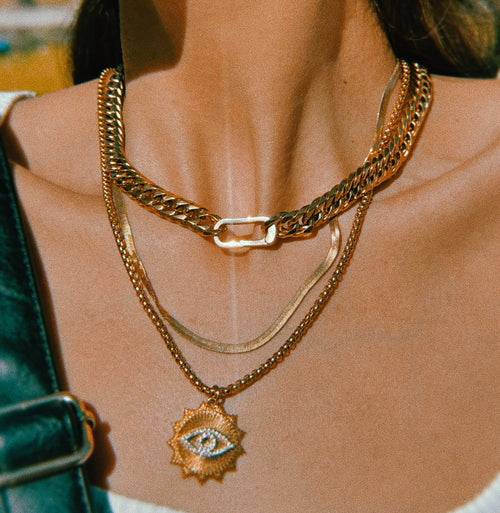 A necklace displayed with natural elements