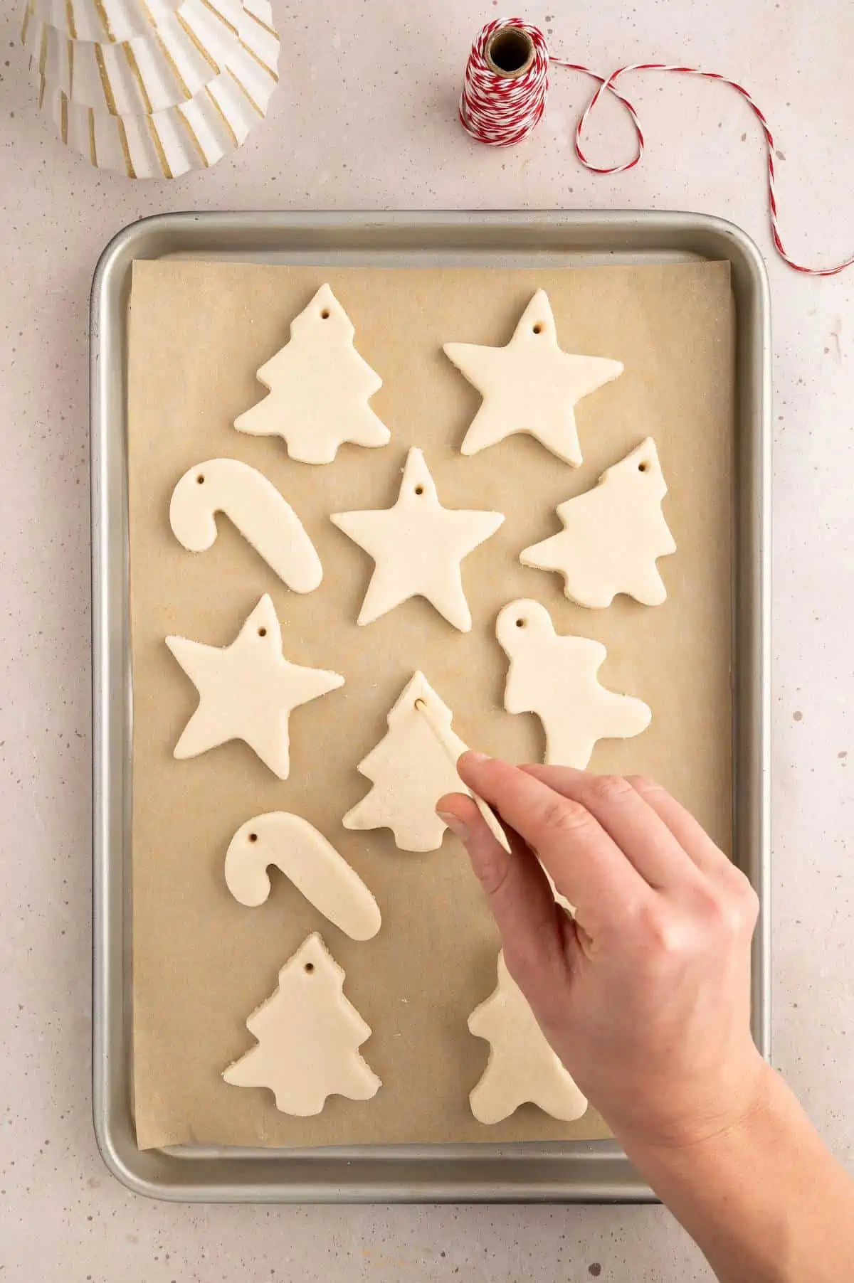 Hands using cookie cutter rosemary dough