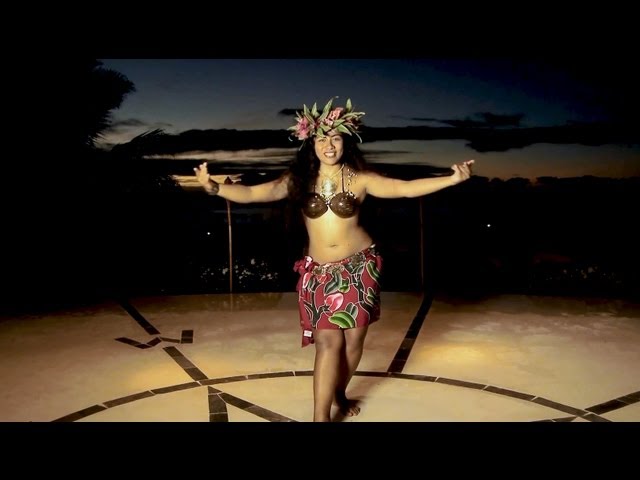 People snorkeling in crystal clear water with colorful fish