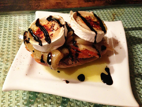 A narrow, winding street in Gracia, Barcelona, with colorful buildings