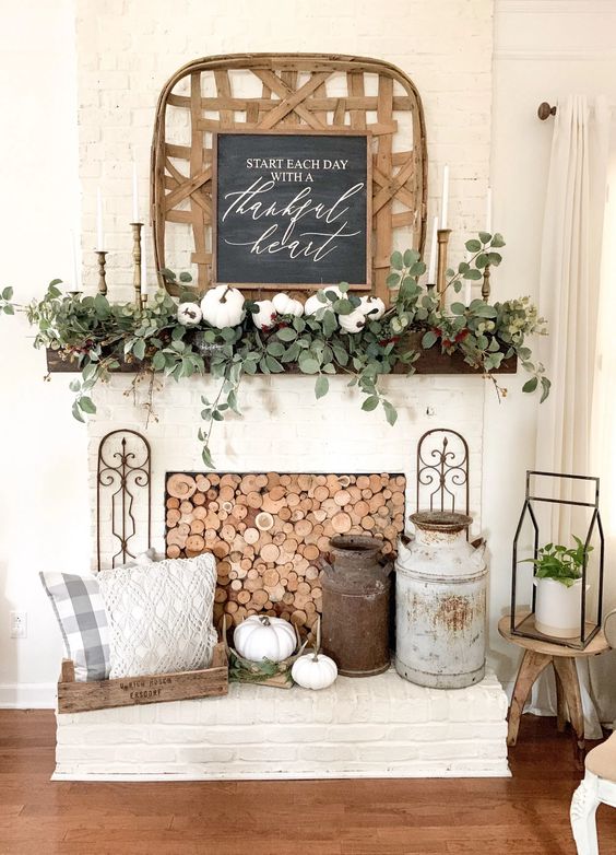 A cozy farmhouse living room at dusk, featuring a fall mantel adorned with foraged and thrifted decor, illuminated by the warm glow of candlelight and a crackling fireplace, creating a serene and inviting atmosphere.