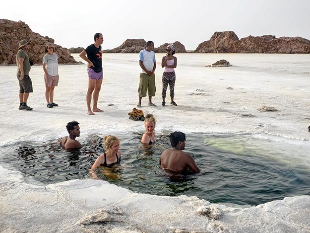 A split-screen showing the difference between standard photograph and infrared photography of a desert landscape. The IR photo is glowing and more visible.