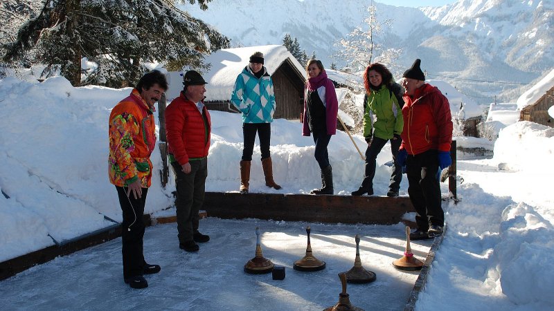 Close-up of an Eisstock disc impacting the ice