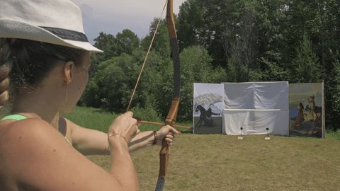 A snowmobile gliding through a snow-covered forest near Lake Baikal during sunset, with a silhouette of the snowmobile against the orange sky