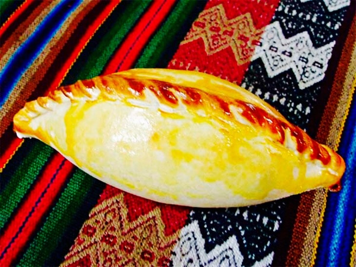 Digital Nomad Holding Empanadas de la Abuela Elena Under the Stars