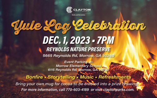 A close-up of a Yule log burning brightly in a fireplace, casting a warm glow.