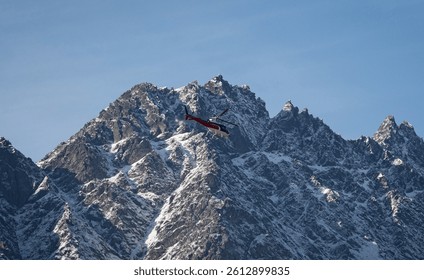 A helicopter in front of Remarkables alpine southern lakes, Queenstown New Zealand