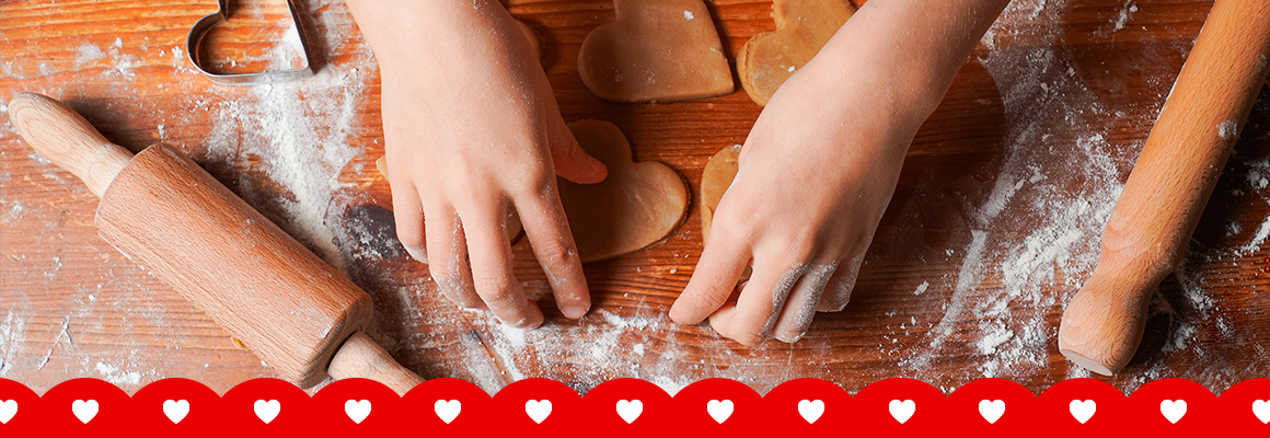 Rolling out dough, with star shaped cookie cutters placed nearby.