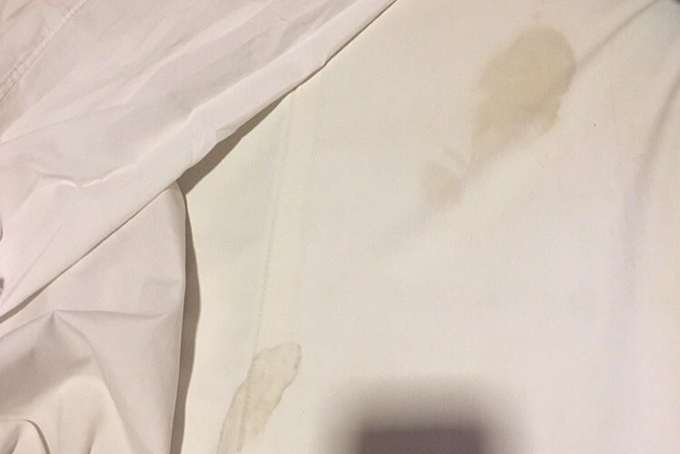 Blurry photo of hand reaching for a bed sheet