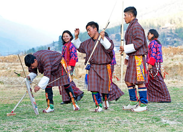 An elderly Bhutanese man smiles warmly, his face etched with wisdom and peace, captured in soft, diffused light. This embodies the essence of Gross National Happiness that Anselm discovered.