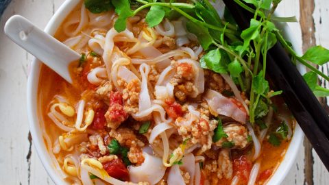 The turquoise pools of Kuang Si Falls surrounded by lush jungle.