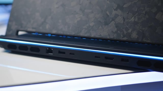 A desaturated, slightly blurred photograph depicting a dimly lit PC repair shop cluttered with disassembled computers. The focus is on a dusty motherboard lying on a workbench, with a single, slightly bent CPU pin visible. The overall mood is one of disappointment and unrealized potential, mirroring the wasted talent of players like leaf in the NA Counter-Strike scene. The lighting is primarily from a single, harsh fluorescent bulb overhead, casting long shadows.