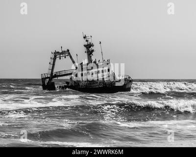 The Eduard Bohlen shipwreck slowly decaying in the harsh Namibian desert, captured in stark black and white.
