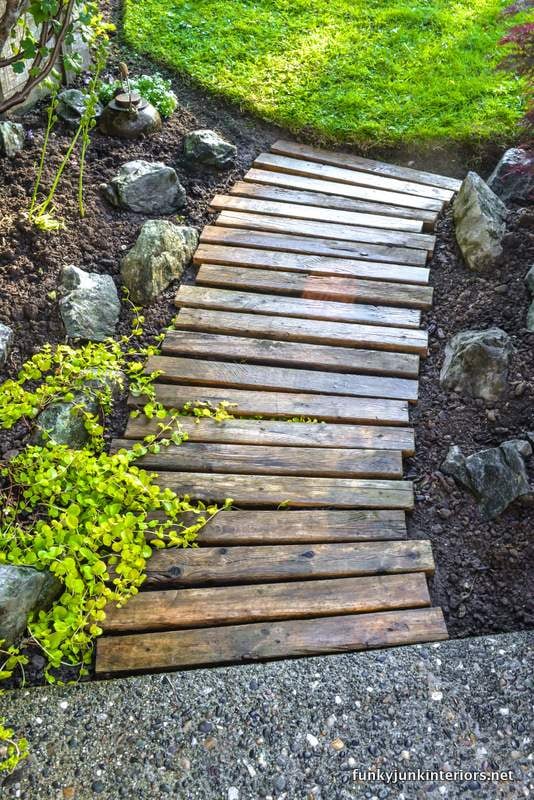 Image of a raised garden bed constructed from pallet wood forming a walkway