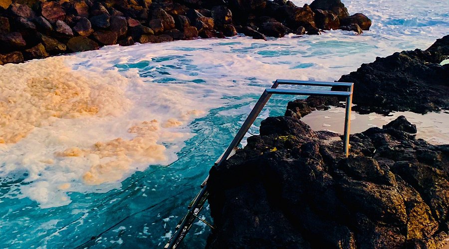 Inside the Gruta do Carvão lava caves, showcasing unique geological formations like lava stalactites and lava tubes.