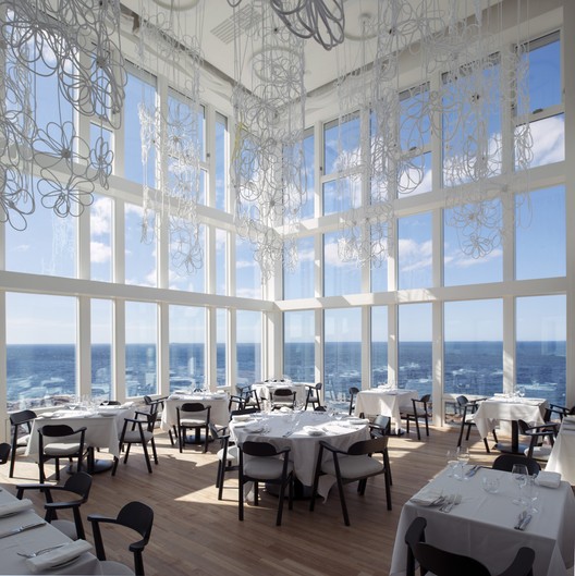 Interior view of Fogo Island Inn, highlighting the timber frame construction and large windows with ocean views