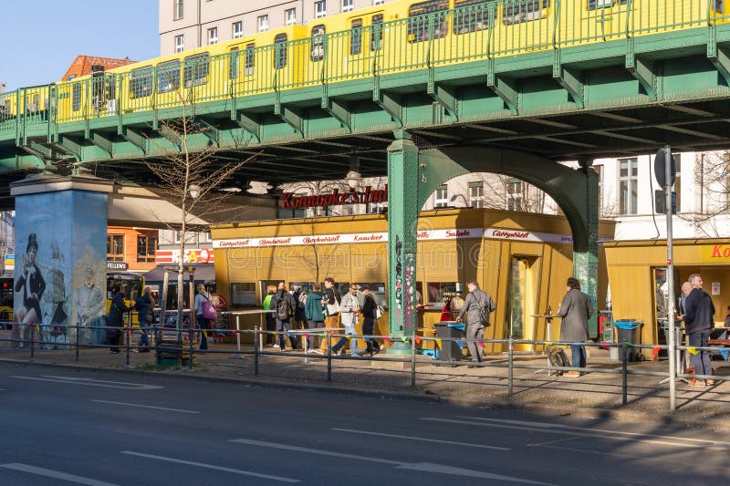 A close-up of a Rüya Gemüse Kebab, showing the variety of grilled vegetables, chicken, and sauces layered in the flatbread.
