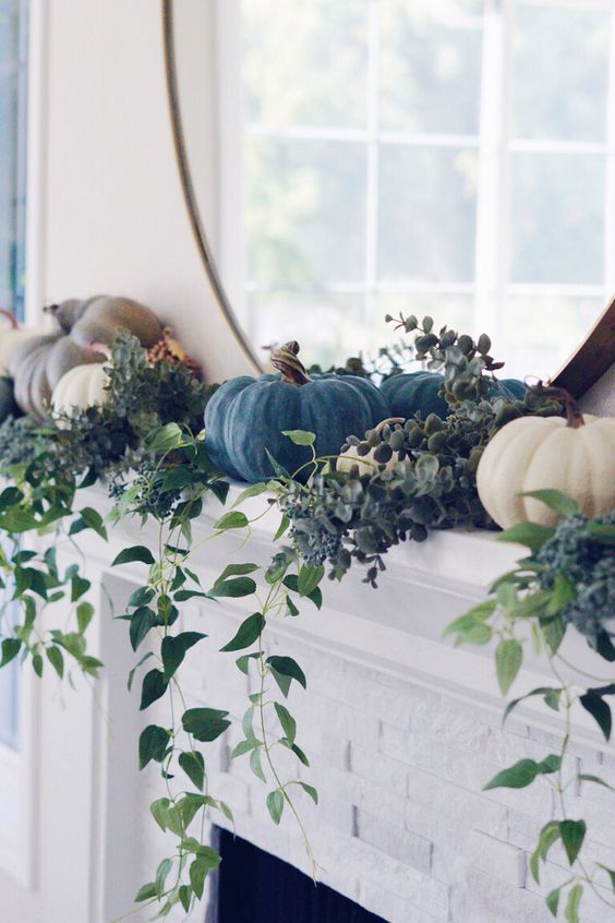 A living room with autumn decor and a fireplace