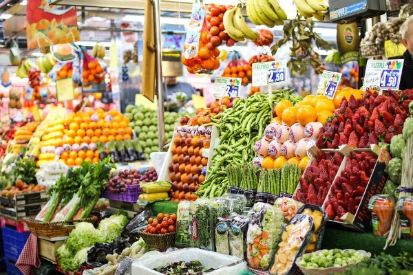 A bustling Roman market stall overflowing with fresh produce