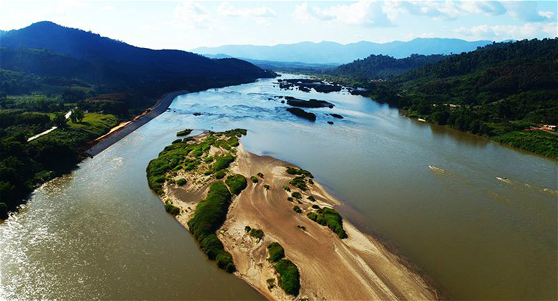 A sign promoting water conservation in Lao and English, highlighting the importance of responsible tourism during Boun Pi Mai Lao.