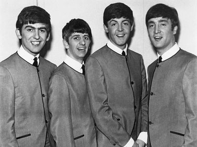 Men in black suits, a common fashion trend in the 1960s
