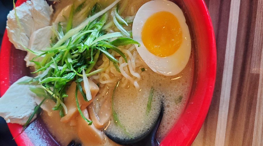 Snowshoeing through Shikaribetsu Lake Kotan, showcasing the expansive frozen lake and ice structures with visitors exploring the area, capturing the surreal winter landscape.